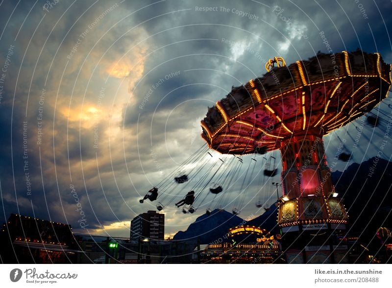 the orchestra plays to the end. Joy Fairs & Carnivals Chairoplane Carousel Trip Summer Event Clouds Storm clouds Sunlight Flying Illuminate Threat Dark