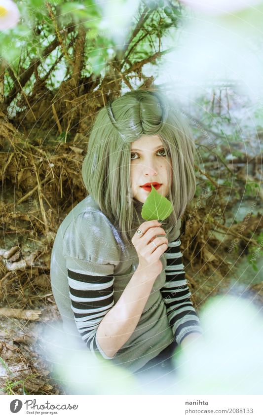 Young woman with a leaf in her hands Human being Feminine Youth (Young adults) 1 18 - 30 years Adults Environment Nature Spring Summer Leaf Forest