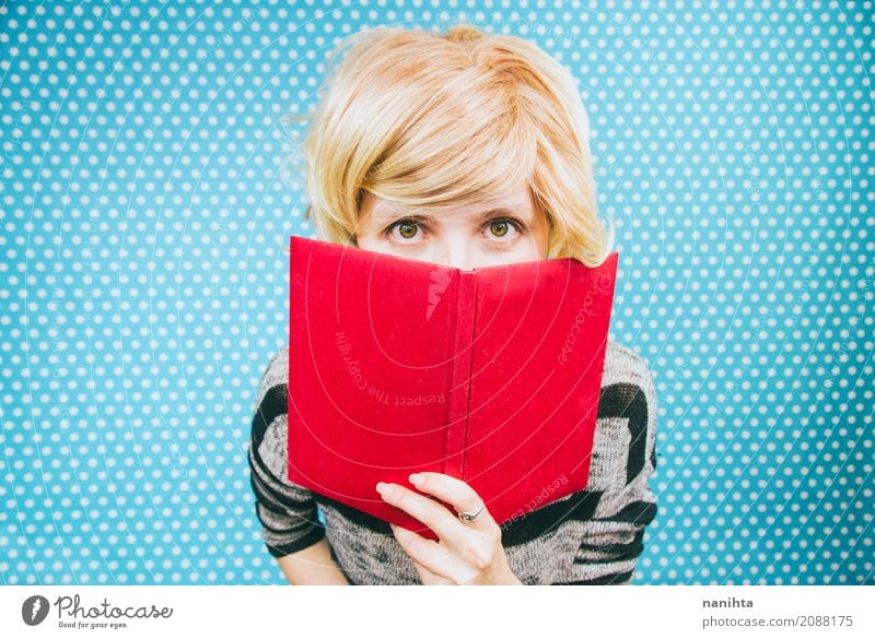 Young blonde woman covered by a book Lifestyle Reading Education Study Student Human being Feminine Young woman Youth (Young adults) 1 18 - 30 years Adults