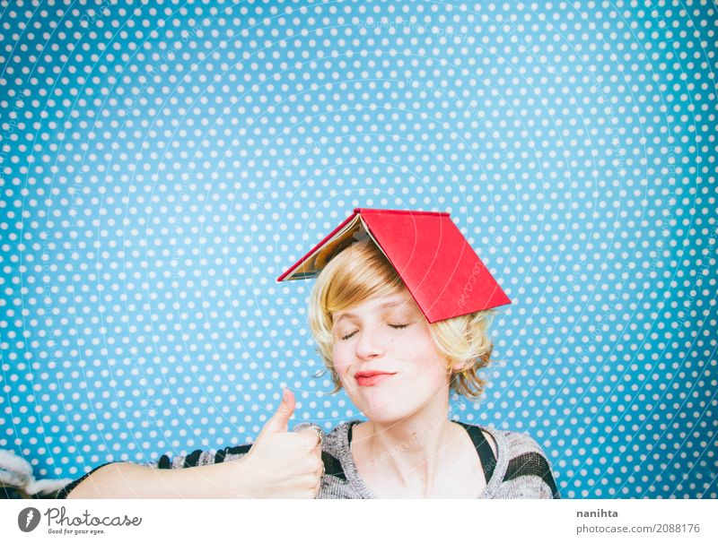 Young and happy woman with a book covering her head Lifestyle Reading Education Study Human being Feminine Young woman Youth (Young adults) 1 18 - 30 years