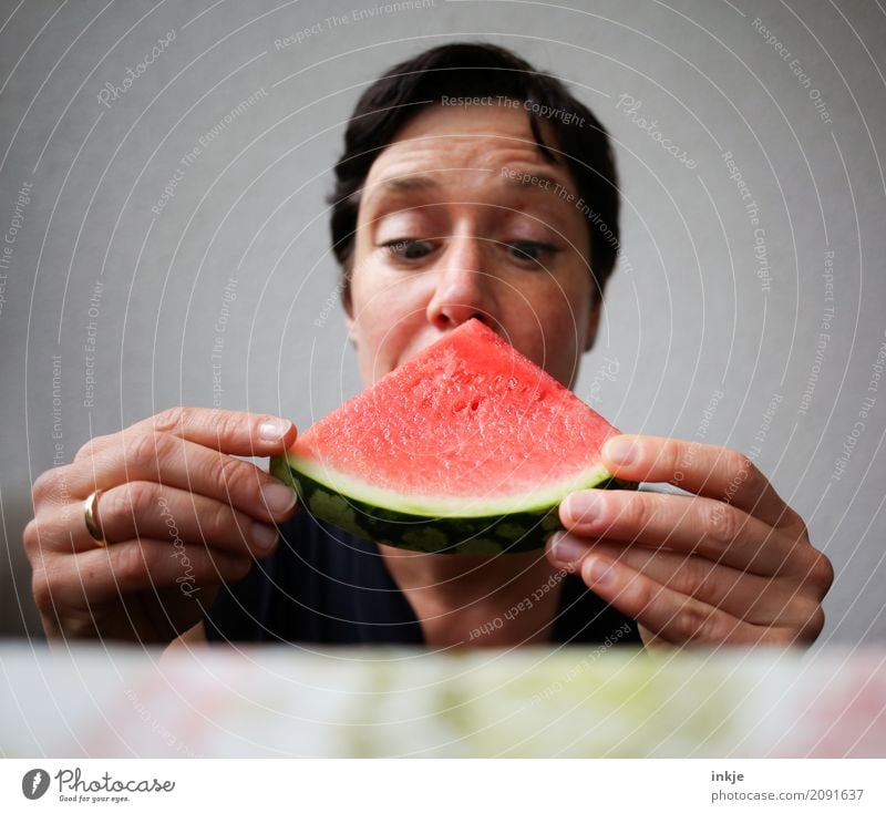 Not so young caucasian woman now almost biting in watermelon Fruit Water melon Melon Nutrition Eating Vegetarian diet Finger food Woman Adults Life Face Hand 1