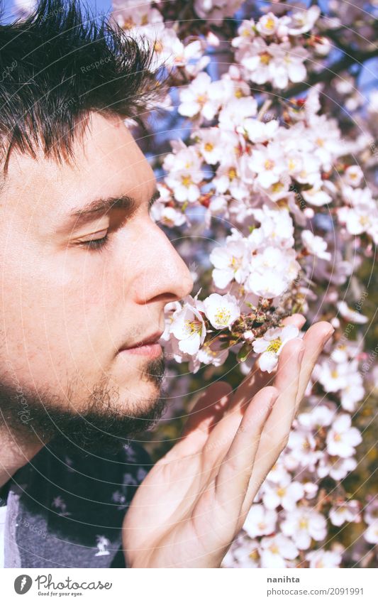 Young man sniff the fragance of flowers Lifestyle Allergy Wellness Well-being Senses Relaxation Calm Human being Masculine Youth (Young adults) Adults 1