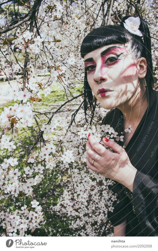 Young woman with a geisha costume pose with white flowers Elegant Style Exotic Beautiful Hair and hairstyles Cosmetics Make-up Carnival Human being Feminine