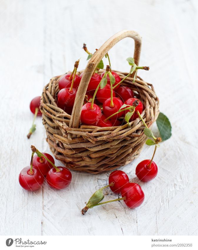 Fresh sour cherries ina basket on a wooden table Fruit Vegetarian diet Diet Summer Table Leaf Dark Delicious Juicy Sour Wild Brown Green Red Berries Cherry food