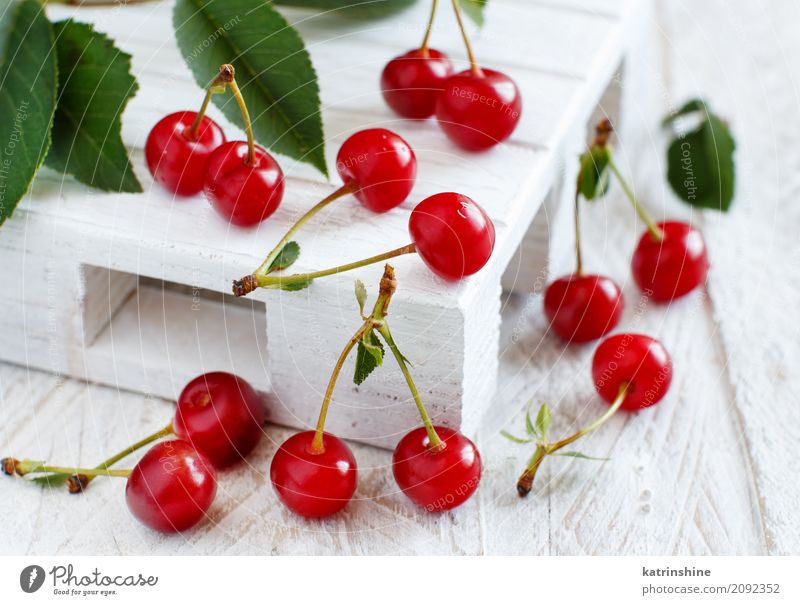 Fresh sour cherries on a white wooden table Fruit Vegetarian diet Diet Bowl Summer Table Leaf Dark Delicious Juicy Sour Wild Brown Green Red Berries Cherry food