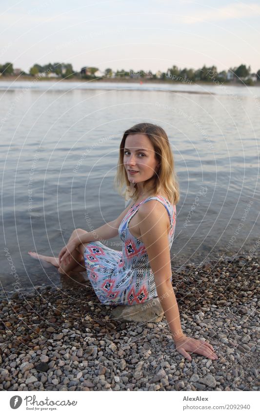 Young woman sitting on the banks of the Rhine with her feet in the water Lifestyle Joy pretty Well-being Trip Youth (Young adults) 18 - 30 years Adults