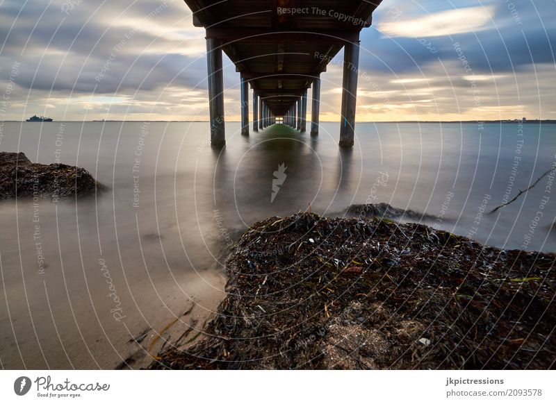 footbridge in fur hook Baltic Sea Coast Ocean Beach Health Spa Autumn Algae Long exposure Footbridge Wood Pole Sky Clouds Sun Sunbeam Water Cold Calm Deserted