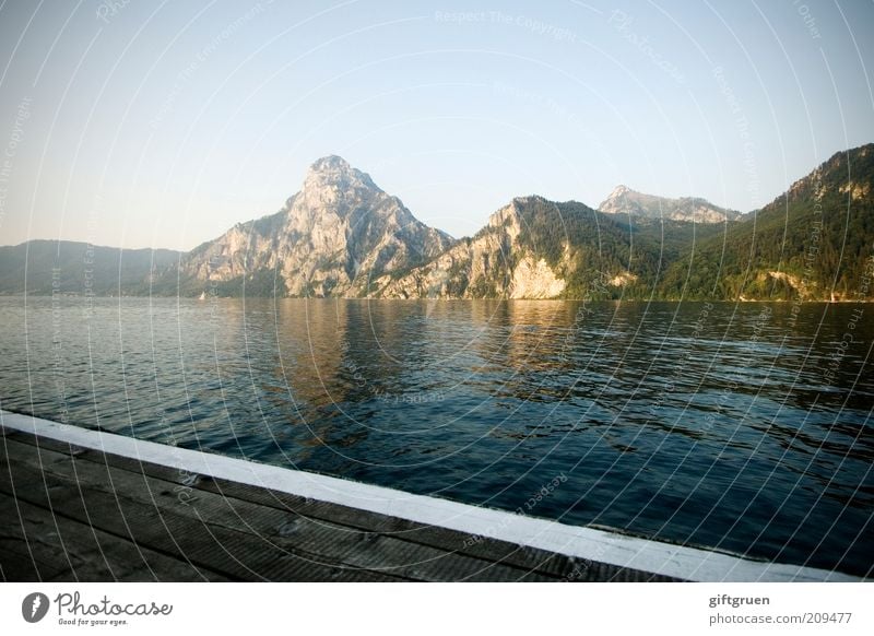 evening Environment Nature Landscape Water Sky Cloudless sky Sunlight Summer Beautiful weather Hill Mountain Peak Lakeside Footbridge Traunsee Salzkammergut