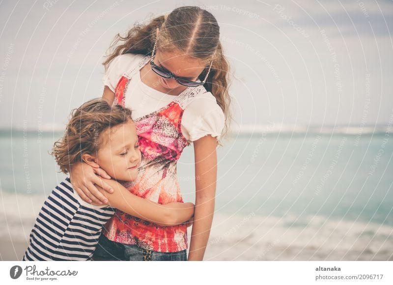 Sister and brother playing on the beach at the day time. Concept Brother And Sister Together Forever Lifestyle Joy Happy Beautiful Relaxation