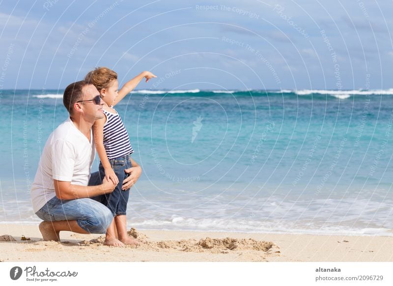 Happy father and son playing on the beach Lifestyle Joy Relaxation Leisure and hobbies Playing Vacation & Travel Trip Freedom Summer Sun Beach Ocean Child