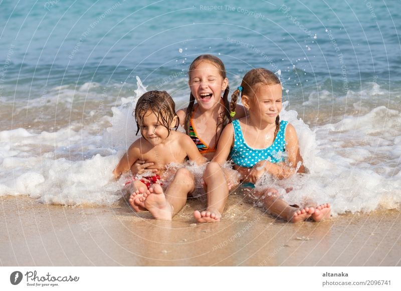 Two sisters and brother playing on the beach at the day time. Concept Brother And Sister Together Forever Lifestyle Joy Happy Beautiful Relaxation