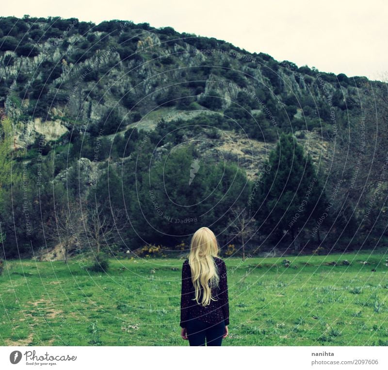 Back view of a young woman standing in front of a mountain Lifestyle Wellness Relaxation Calm Vacation & Travel Tourism Adventure Freedom Human being Feminine