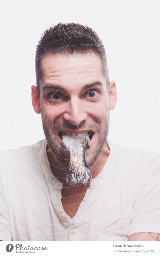 Young man with raw fish in his mouth Food Fish Nutrition Eating Lunch Slow food Shopping Healthy Healthy Eating Leisure and hobbies Fishing (Angle) Cook