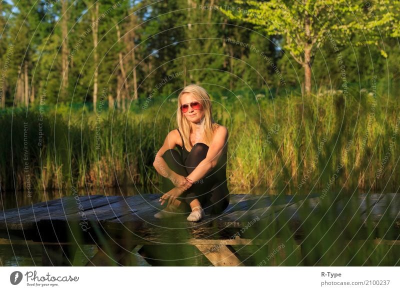 A pretty dancer is taking a break on a pear Human being Feminine Woman Adults Nature Wall (barrier) Wall (building) Clothing Blonde Break cigarette artistic