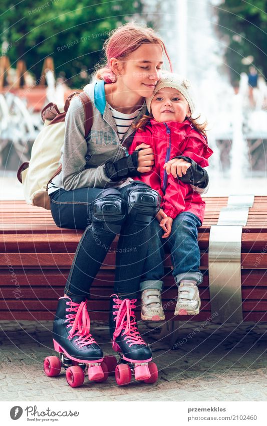 Young girl hugging her little sister while sitting on bench Lifestyle Child Toddler Girl Sister Family & Relations 2 Human being 1 - 3 years 13 - 18 years