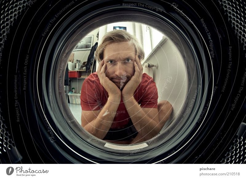 who needs TV? Living or residing Masculine Man Adults 30 - 45 years Wait Round Boredom Washer Laundry Clean Washing Colour photo Interior shot