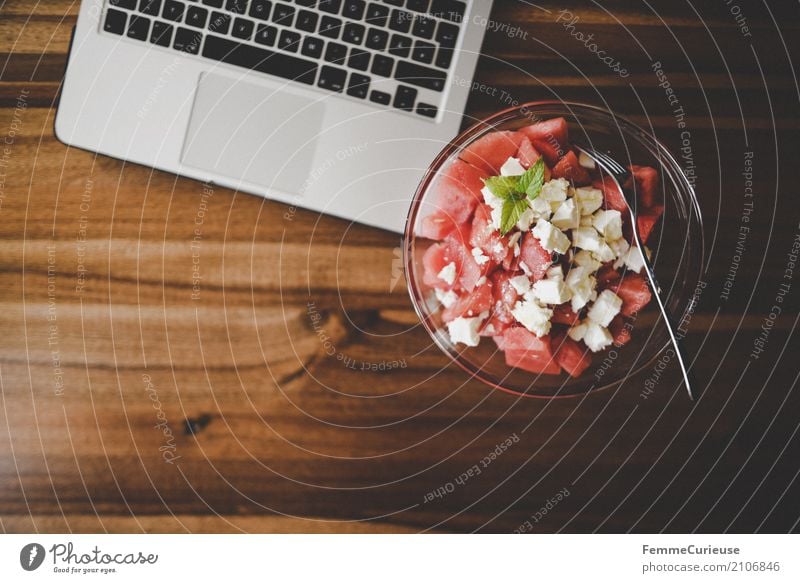 Home office (07) Food Nutrition Notebook Melon feta Lettuce Mint leaf Fork Glass bowl Wooden table Workplace Keyboard Colour photo Interior shot Copy Space left