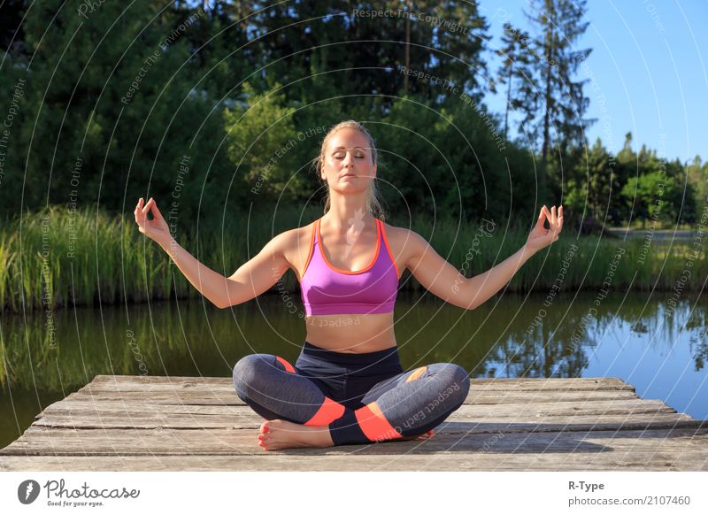 A sporty woman doing yoga and stretching exercises Lifestyle Wellness Sports Yoga Human being Woman Adults Nature Park Fashion Blonde Fitness aerobics active