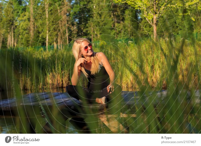 A pretty dancer is taking a break on a pear Human being Feminine Woman Adults Nature Wall (barrier) Wall (building) Clothing Blonde Break cigarette Acrobat