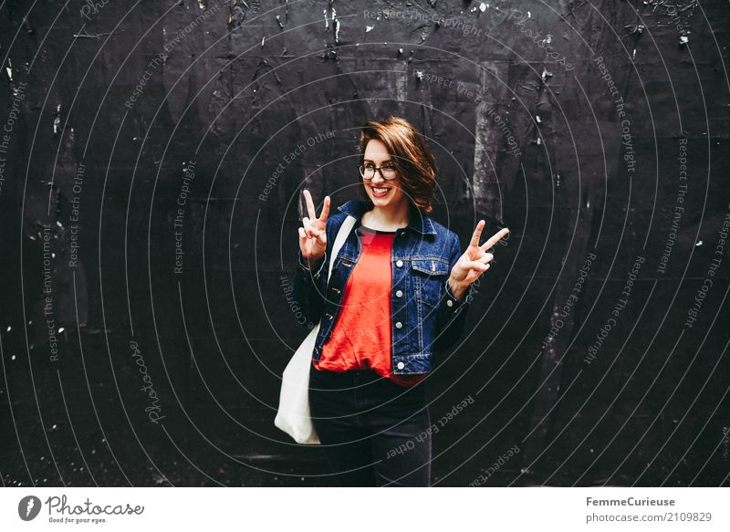 Young attractive brunette woman with glasses in front of black wall shows Victory sign with her hands Feminine Young woman Youth (Young adults) Woman Adults 1