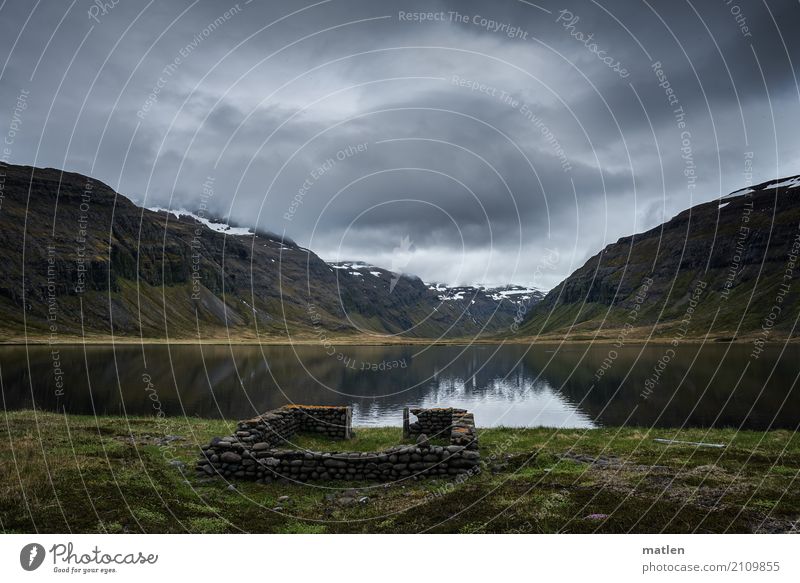 The lake rests still Nature Landscape Water Sky Clouds Horizon Spring Grass Rock Mountain Lakeside Brown Gray Green Iceland Ruin Colour photo Subdued colour