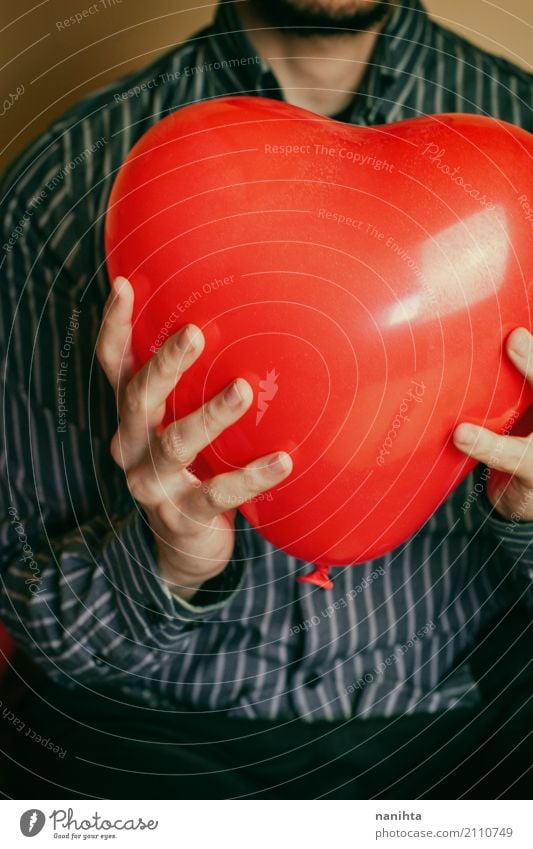 Young man holding a red heart shaped balloon Lifestyle Healthy Health care Wellness Well-being Human being Masculine Youth (Young adults) 1 18 - 30 years Adults