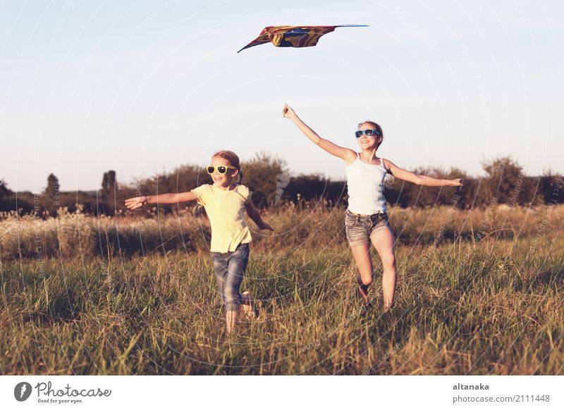 Happy children playing on the field at the day time. Concept of friendly siblings of family. Lifestyle Joy Beautiful Leisure and hobbies Playing