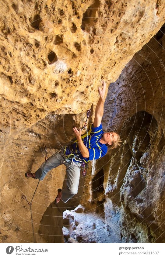 Climber clinging to a cliff. Adventure Sports Climbing Mountaineering Rope Athletic Tall Bravery Self-confident Optimism Power Willpower Determination