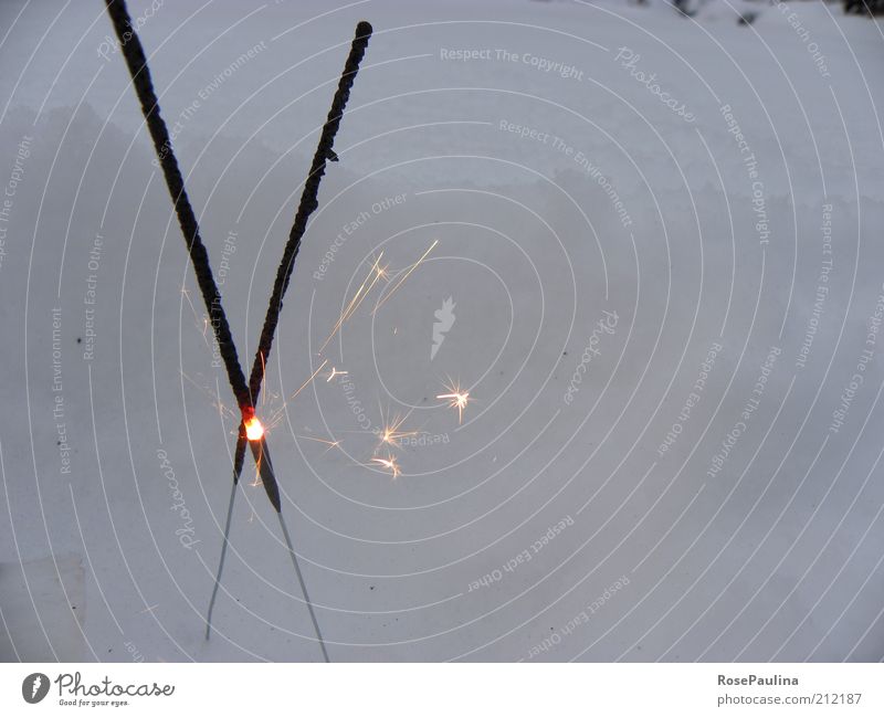 Fire and ice Snow Illuminate Hot Bright Warmth Yellow Gold Black Esthetic Uniqueness Elegant Cold Winter Sparkler Colour photo Exterior shot Close-up Detail