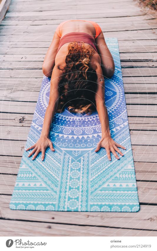 Young woman doing yoga and stretching exercise on yoga mat Lifestyle Wellness Relaxation Leisure and hobbies Sports Fitness Sports Training Yoga Human being