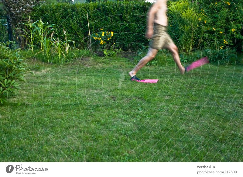 One more step... Joy Human being Man Adults Plant Grass Going August Water wings Colour photo Lawn Running Walking Green space Garden Motion blur Headless