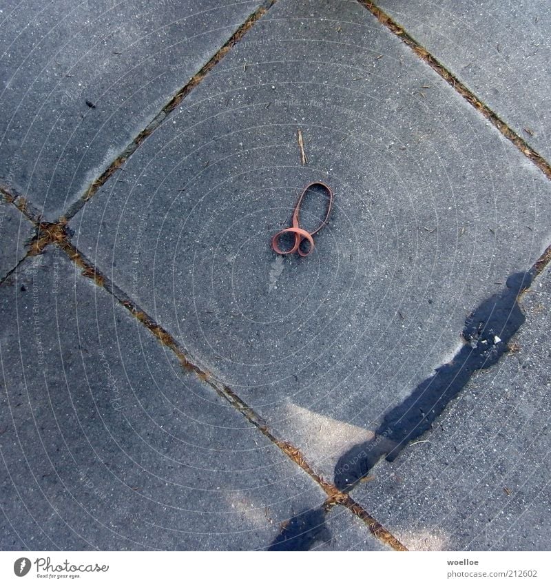 rubber cane Concrete Sign Bow Penis Lie Fat Dirty Large Round Trashy Gray Red Rubber Colour photo Subdued colour Exterior shot Detail Deserted