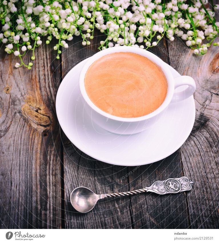 Cup of coffee and an iron spoon To have a coffee Hot drink Coffee Mug Spoon Table Flower Bouquet Wood Above Retro Gray Black White Lily of the valley Top