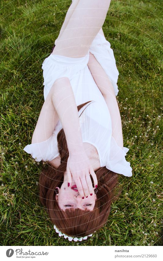 Young woman lying down in a field of grass Lifestyle Elegant Style Beautiful Human being Feminine Youth (Young adults) 1 18 - 30 years Adults Nature Plant