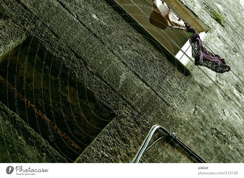 house Building Wall (building) Facade Clothing drying Hanging space Ancient Old Run-down Earth hole Yellow Poverty simplicity Agitation metropolis Portugal