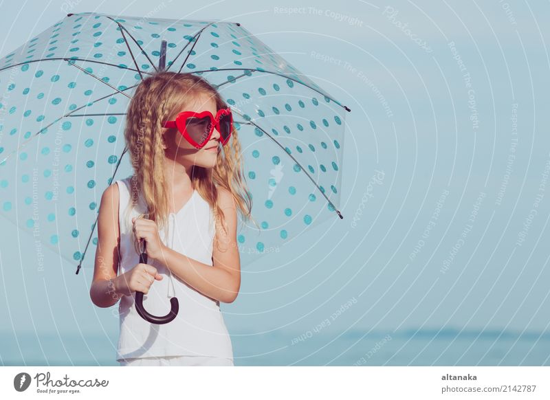 Little girl with umbrella standing on the beach at the day time Lifestyle Joy Happy Beautiful Relaxation Leisure and hobbies Playing Vacation & Travel Freedom