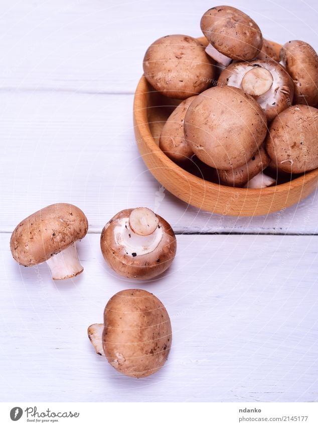 Fresh mushrooms champignon Vegetable Nutrition Eating Vegetarian diet Bowl Kitchen Wood Brown White whole Top Mushroom healthy knife cook Cooking Ingredients