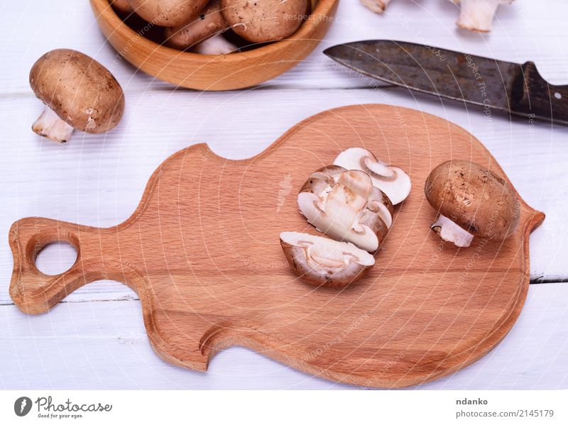 Chopped fresh mushrooms Vegetable Vegetarian diet Bowl Knives Kitchen Wood Fresh Brown White Champignon Mushroom board knife Top background food Edible Raw