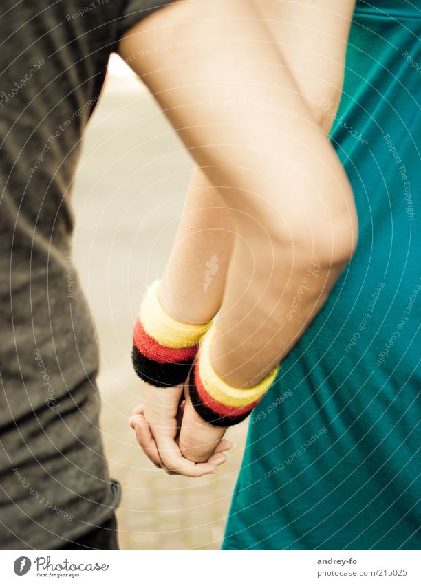 hand in hand Arm Hand 2 Human being sweatband Touch Embrace Friendliness Together Yellow Red Black Emotions Trust Love Friendship Idyll German Flag Bracelet