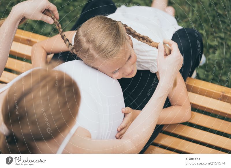 Happy little girl hugging mother in the park at the day time. Lifestyle Joy Leisure and hobbies Vacation & Travel Tourism Trip Adventure Freedom Camping Summer