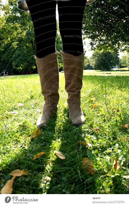 sunblock Legs Feet 1 Human being Summer Park Meadow Stand Self-confident Calm Leisure and hobbies Boots Tights Sunlight Green Back-light Multicoloured