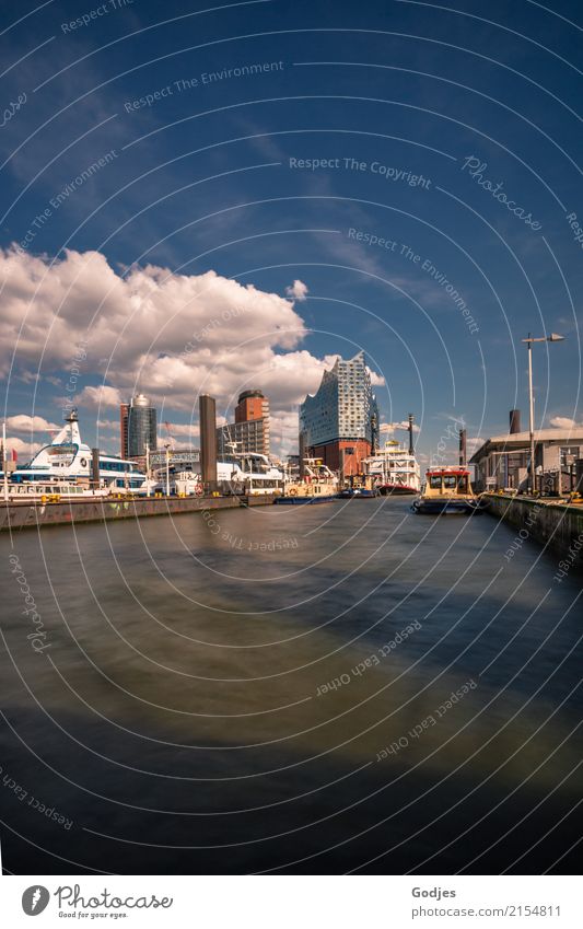 View over the Elbe to the Elbphilharmonie, skyline with ships and buildings at the waterfront Port of Hamburg Landungsbrücken Capital city Port City Deserted