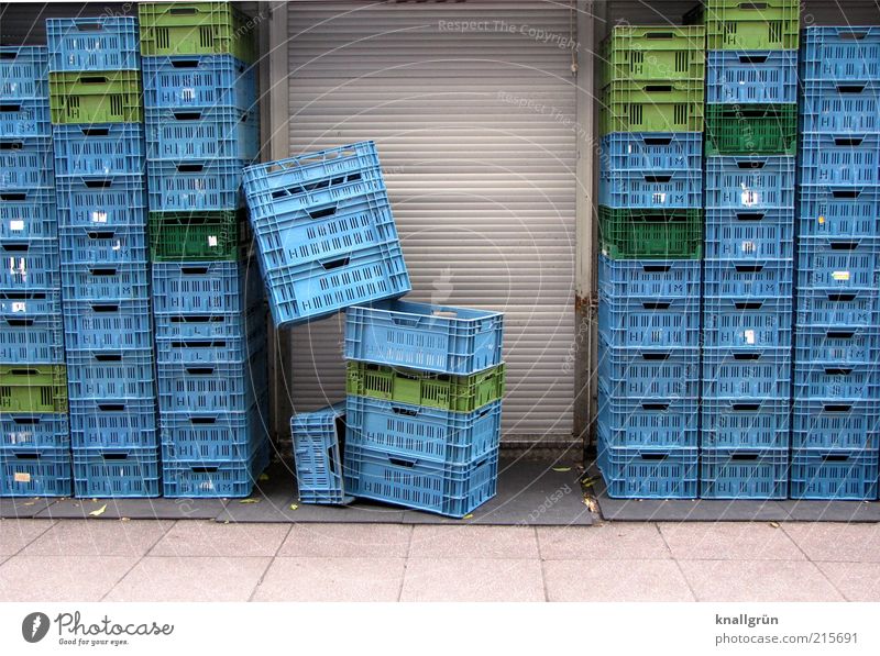 consumption Door Roller shutter Sharp-edged Tall Blue Gray Green Arrangement Supermarket transport box Plastic basket Stack Colour photo Exterior shot Deserted