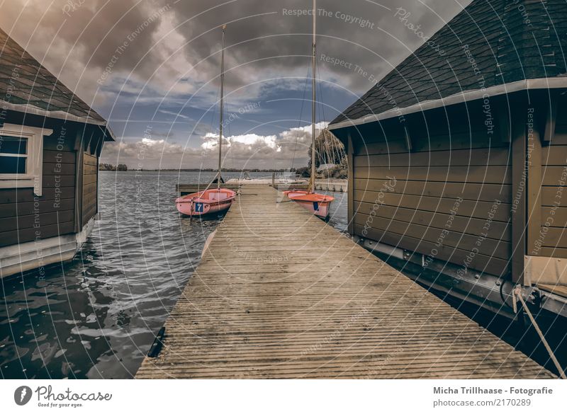 Boathouses and sailboats at the jetty Leisure and hobbies Sailing Vacation & Travel Tourism Waves House (Residential Structure) Nature Landscape Water Sky