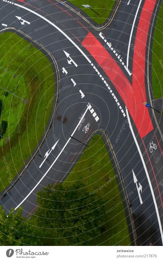 regular Deserted Transport Traffic infrastructure Road traffic Street Crossroads Road sign Gray Green Red Cycle path Arrow Lane change Meadow Asphalt