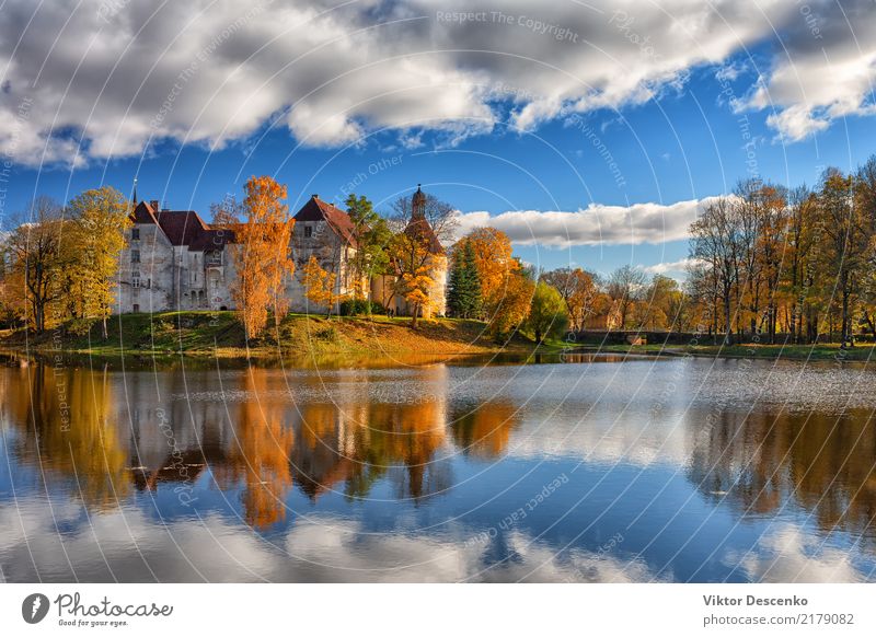 Ancient castle by the lake in autumn Beautiful Vacation & Travel Tourism Island Winter Culture Nature Landscape Sky Autumn Tree Pond Lake Castle Bridge Building