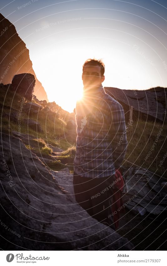 Young man with lumberjack shirt backlit in mountain evening atmosphere Harmonious Well-being Senses Calm Vacation & Travel Adventure Far-off places Freedom