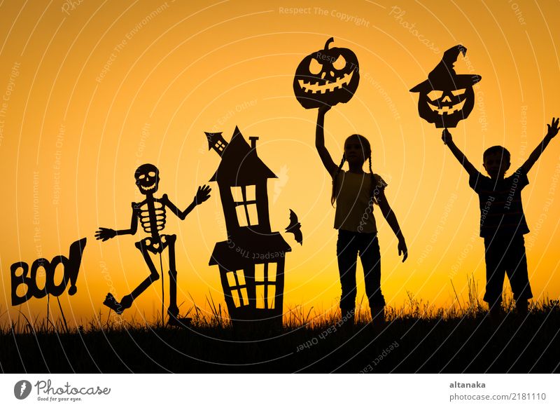 Happy brother and sister playing outdoors Lifestyle Joy Playing House (Residential Structure) Feasts & Celebrations Hallowe'en Child Human being Boy (child)