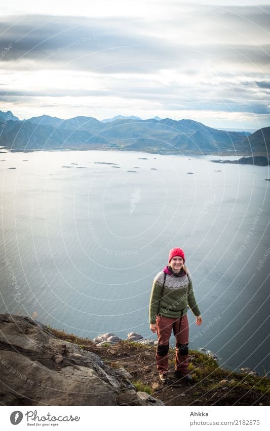 Young woman standing on a cliff above Lofoten Vacation & Travel Adventure Far-off places Freedom Hiking Youth (Young adults) Landscape Fjord Ocean Lofotes