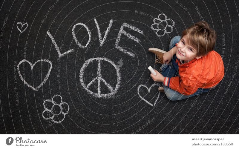 Boy with chalk wants peace and love Human being Masculine Child Boy (child) Infancy Life 1 3 - 8 years Street Jeans Chalk Chalk drawing Smiling Laughter Love